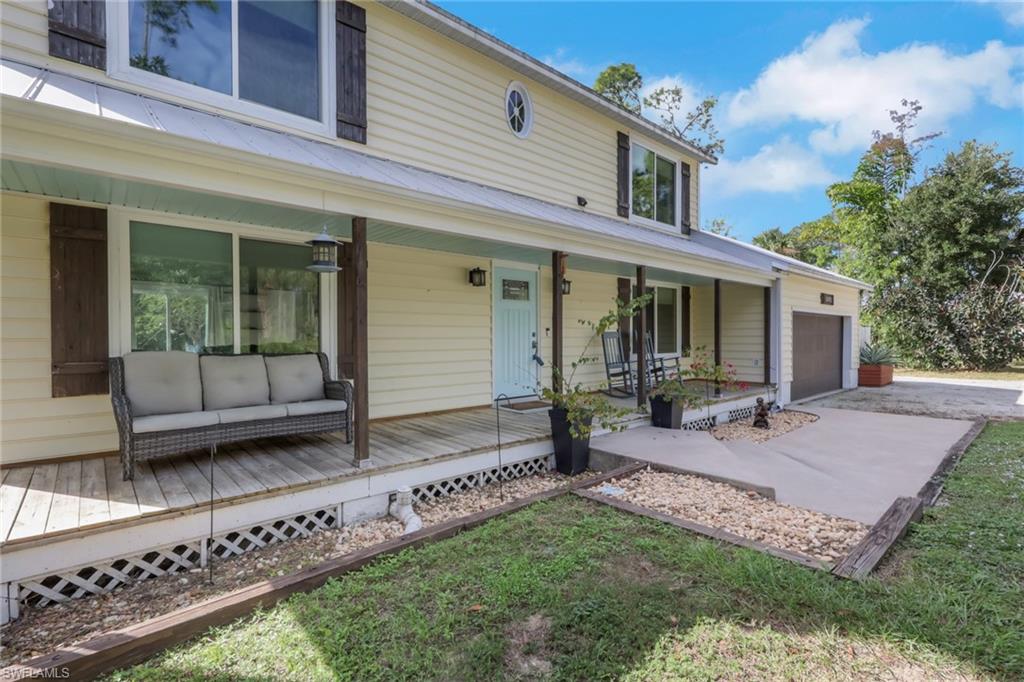 5092 Boxwood Way Naples, FL 34116 - Photo 47 of 48 Lovely wood deck along the front of the home. Enjoy your morning coffee here or relax after a long day and enjoy the sunset.