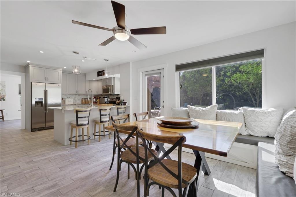 5092 Boxwood Way Naples, FL 34116 - Photo 7 of 48 a view of a dining room with furniture window and wooden floor