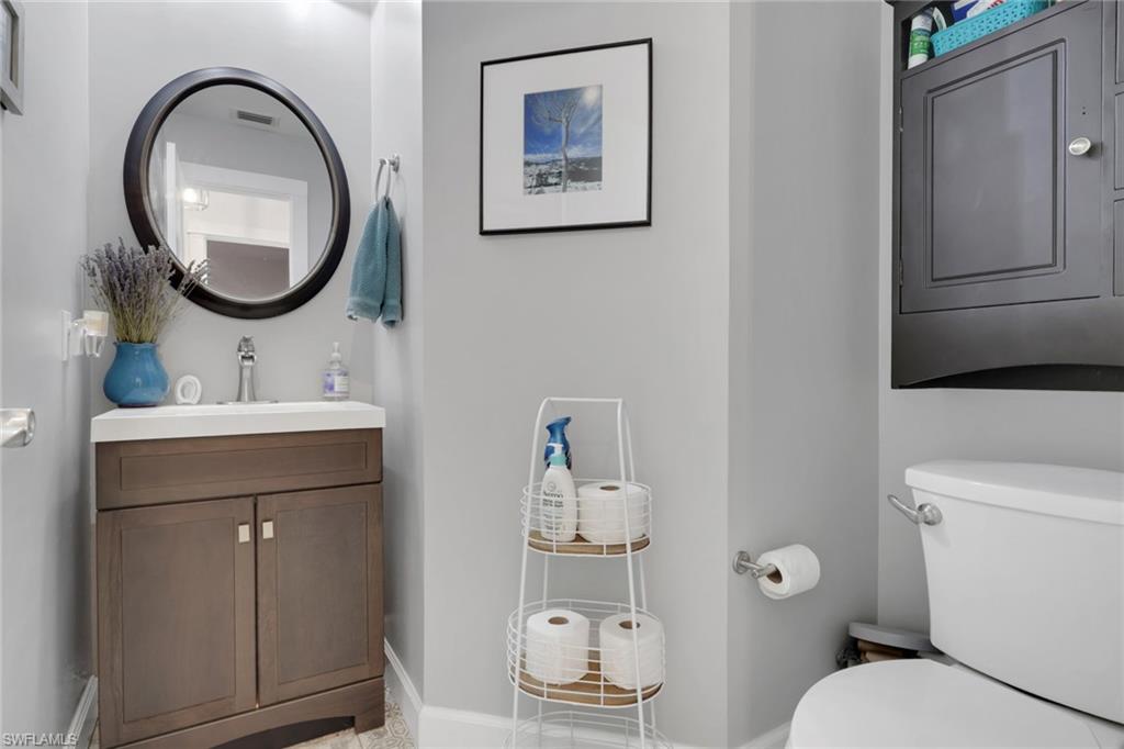 5092 Boxwood Way Naples, FL 34116 - Photo 10 of 48 a bathroom with a toilet a sink and a mirror