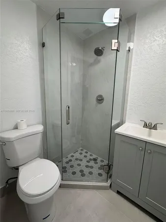 a bathroom with a sink toilet and shower