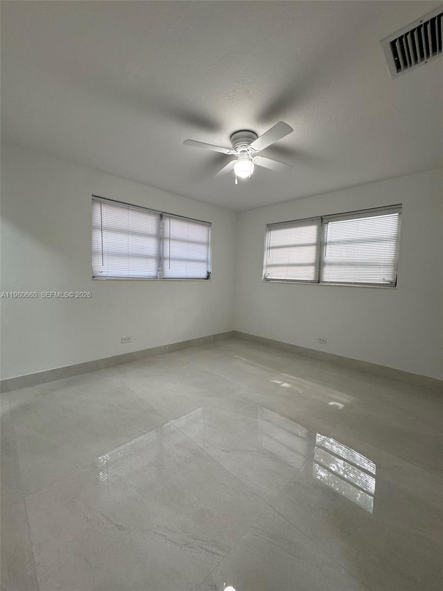 664 Colson Drive Key Largo, FL 33037 - Photo 15 of 23 en empty room with windows and ceiling fan
