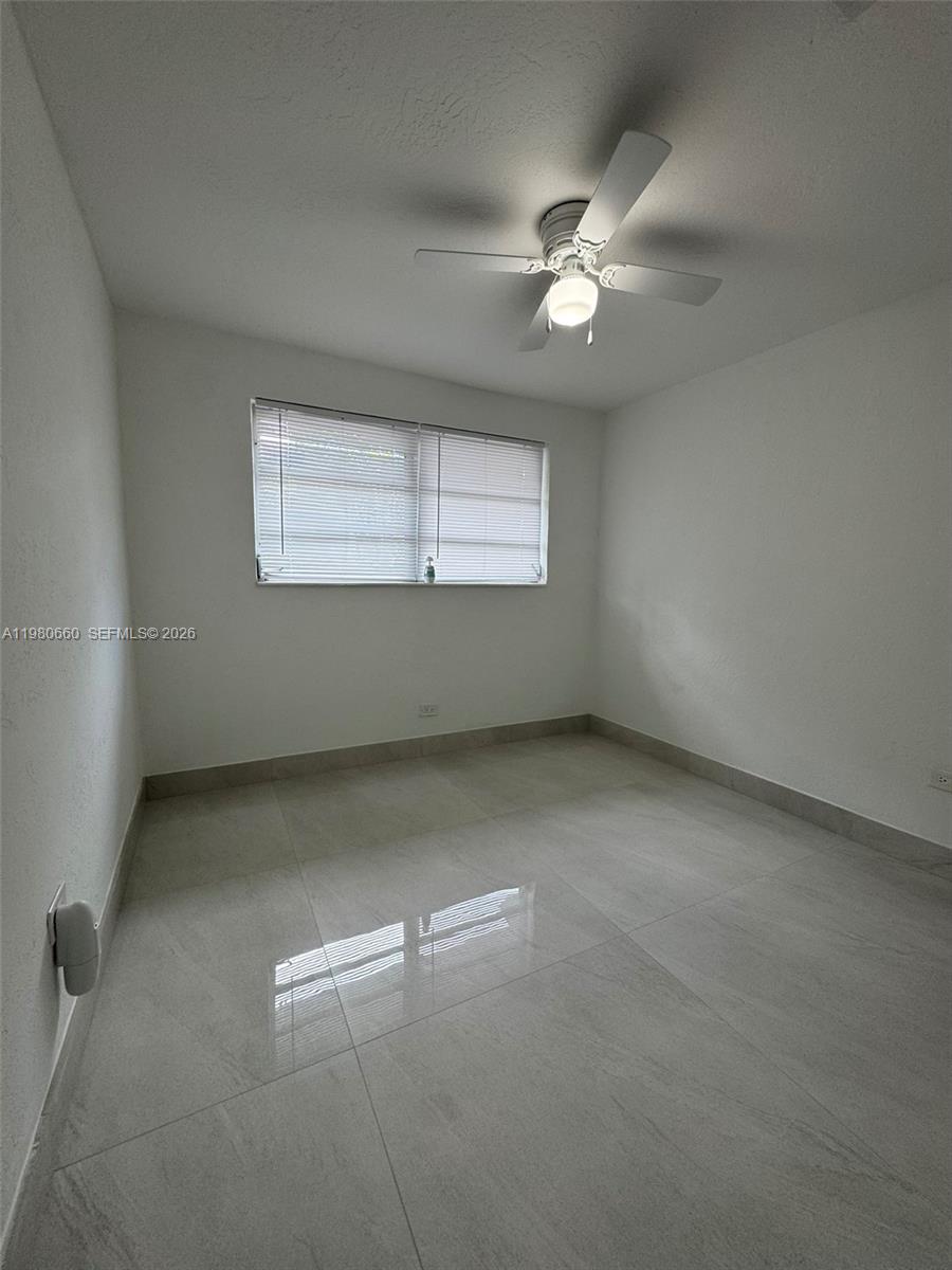 664 Colson Drive Key Largo, FL 33037 - Photo 17 of 23 an empty room with windows and fan