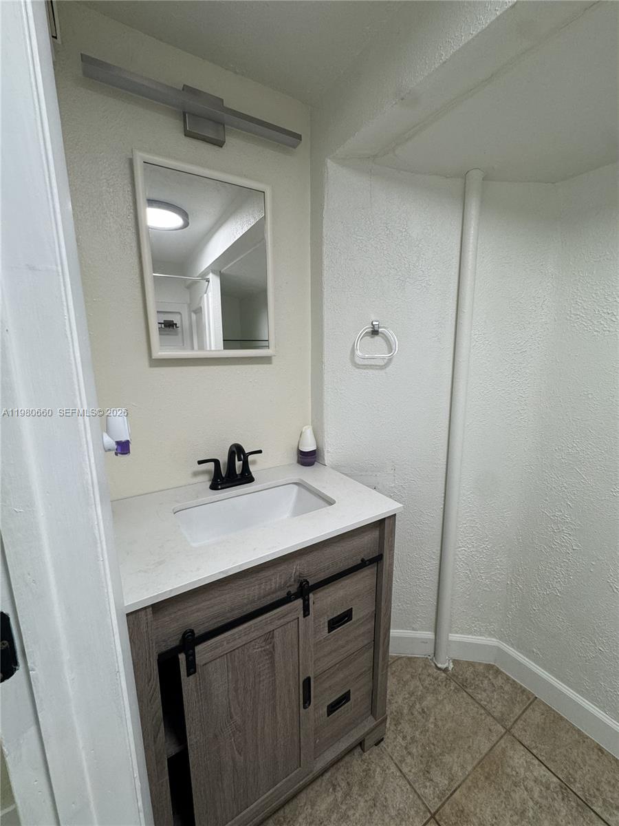 664 Colson Drive Key Largo, FL 33037 - Photo 22 of 23 a bathroom with a sink a vanity and a mirror