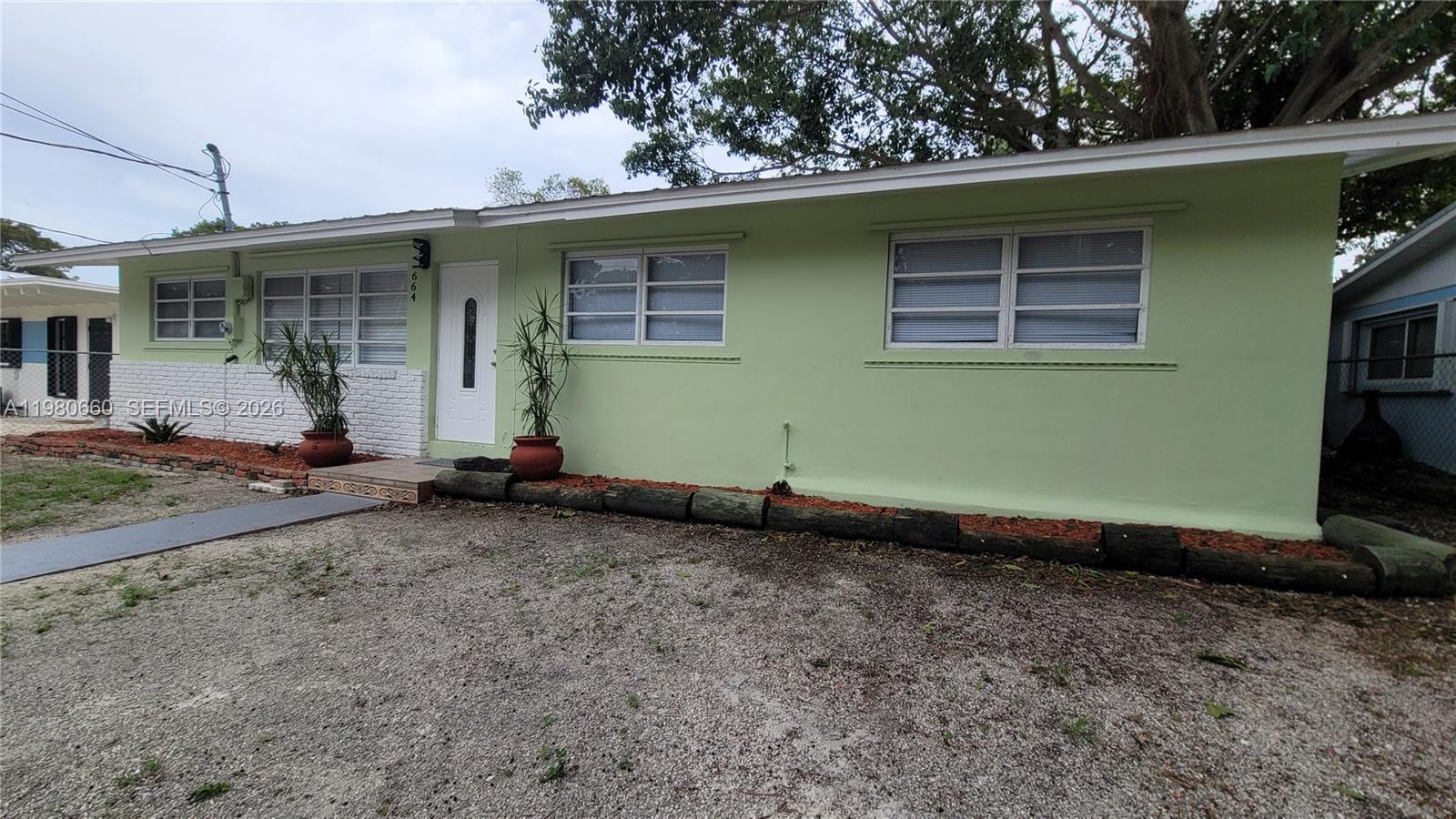 664 Colson Drive Key Largo, FL 33037 - Photo 3 of 23 a front view of a house with a yard