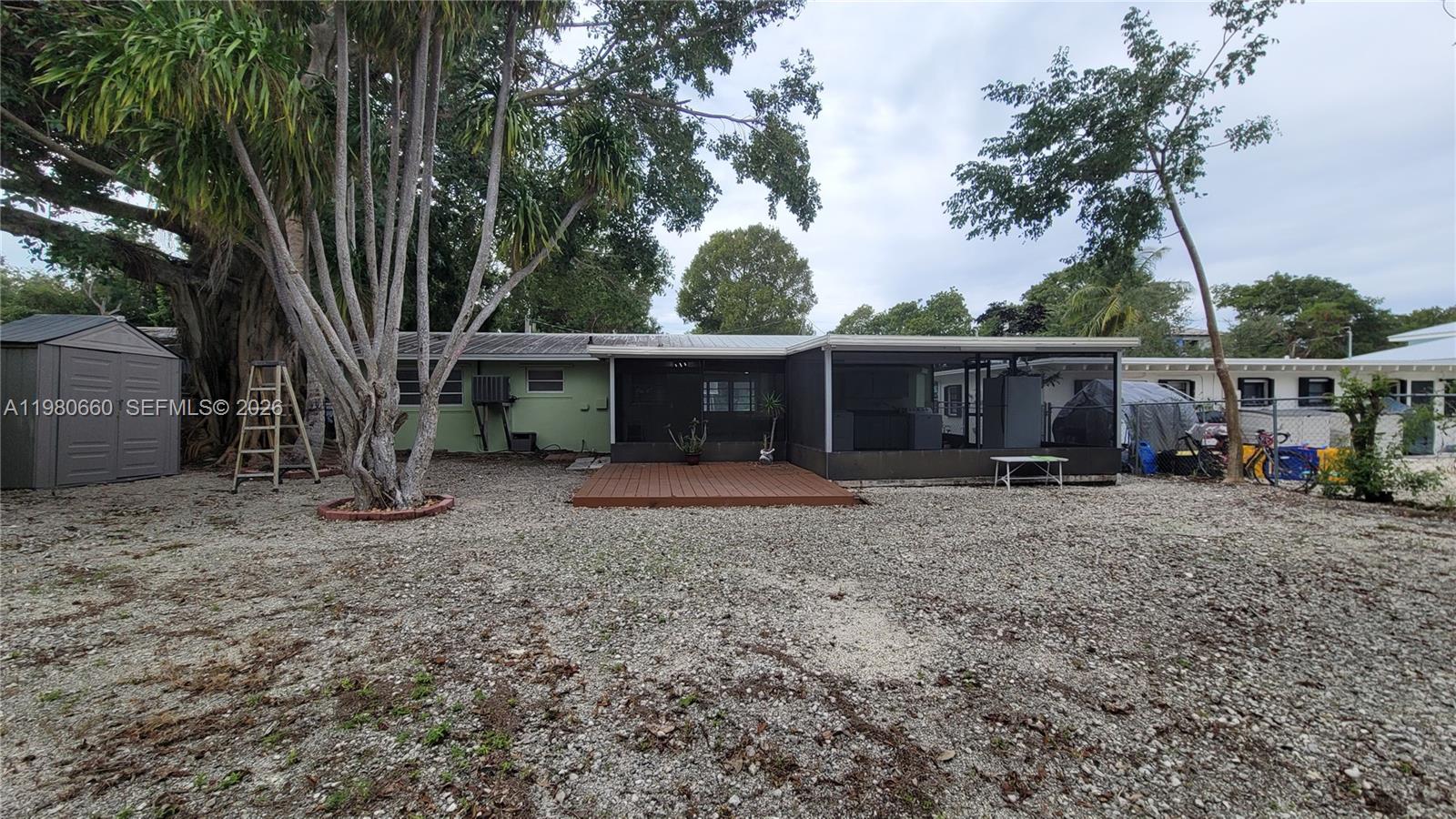 664 Colson Drive Key Largo, FL 33037 - Photo 6 of 23 a view of a house with backyard and a tree