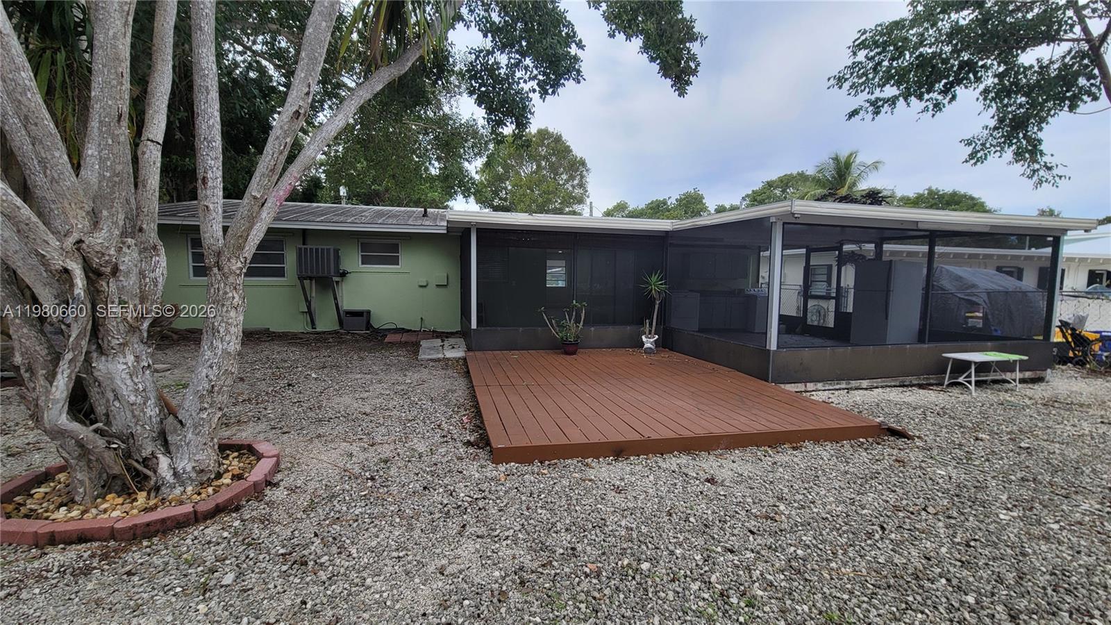 664 Colson Drive Key Largo, FL 33037 - Photo 7 of 23 a front view of a house with a yard and garage