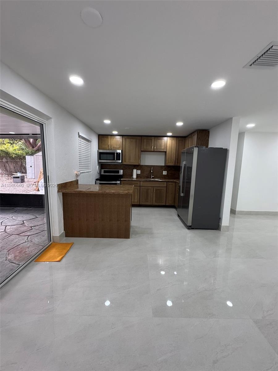 664 Colson Drive Key Largo, FL 33037 - Photo 9 of 23 a view of kitchen with kitchen island and stainless steel appliances