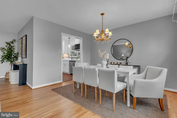 a view of a dining room with furniture and chandelier