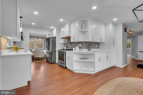 a kitchen with stainless steel appliances sink refrigerator and cabinets
