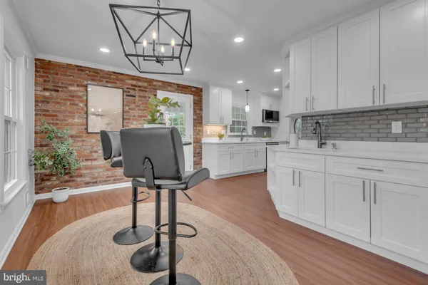 a kitchen with stainless steel appliances granite countertop a stove refrigerator sink cabinets and wooden floor
