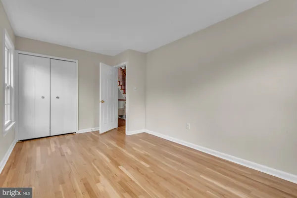 a view of an empty room and wooden floor