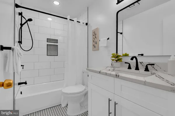 a bathroom with a sink a toilet and a bathtub