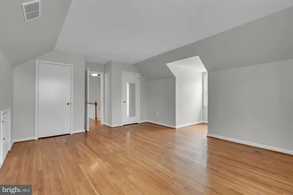 a view of an empty room and wooden floor