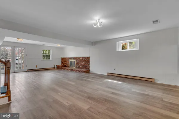 a view of a kitchen with a sink fridge and wooden floor