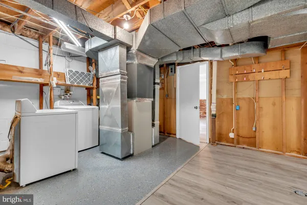 a view of walk in closet with wooden floor