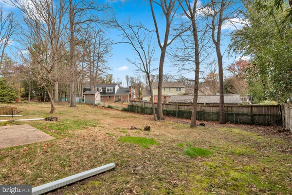 a front view of a house with a garden and trees