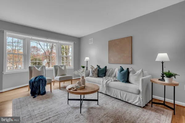 a living room with furniture and a lamp