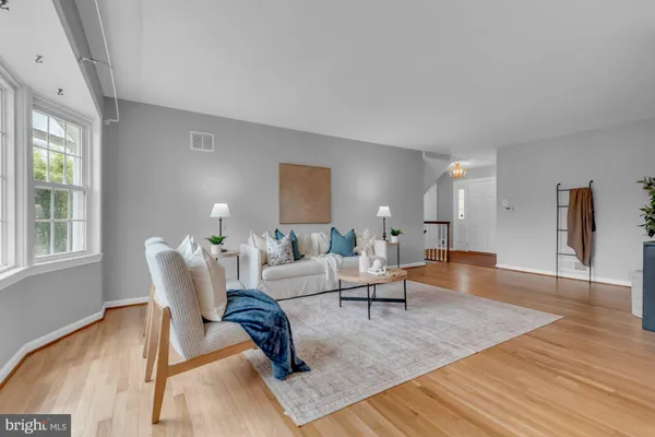 a living room with furniture rug and window