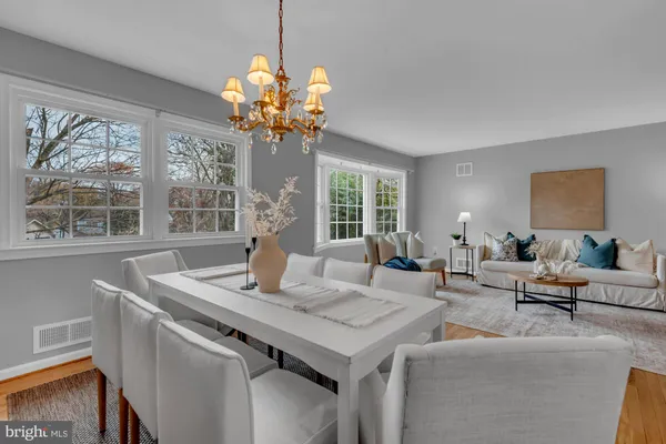a view of a dining room with furniture a livingroom and chandelier