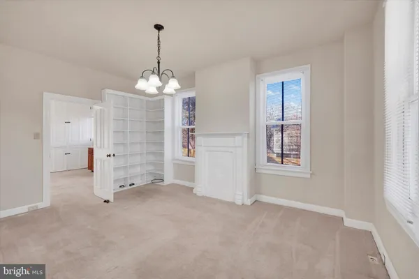 an empty room with windows and entrance