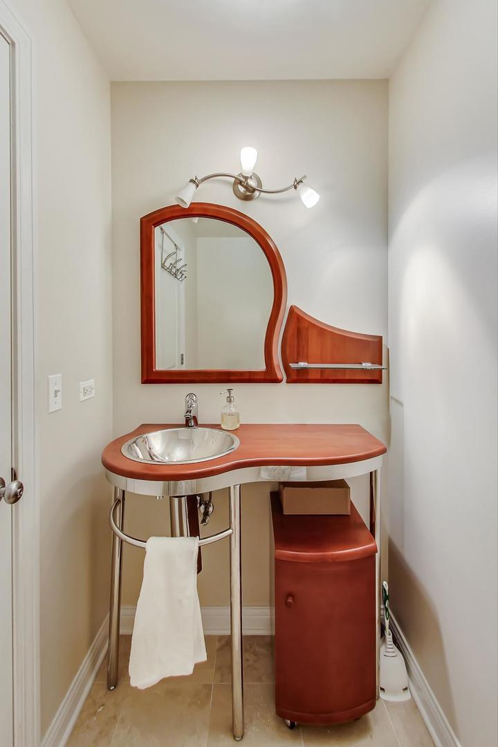 230 West Division Street, Unit 1307 Chicago, IL 60610 - Photo 13 of 33 a bathroom with a sink and a mirror