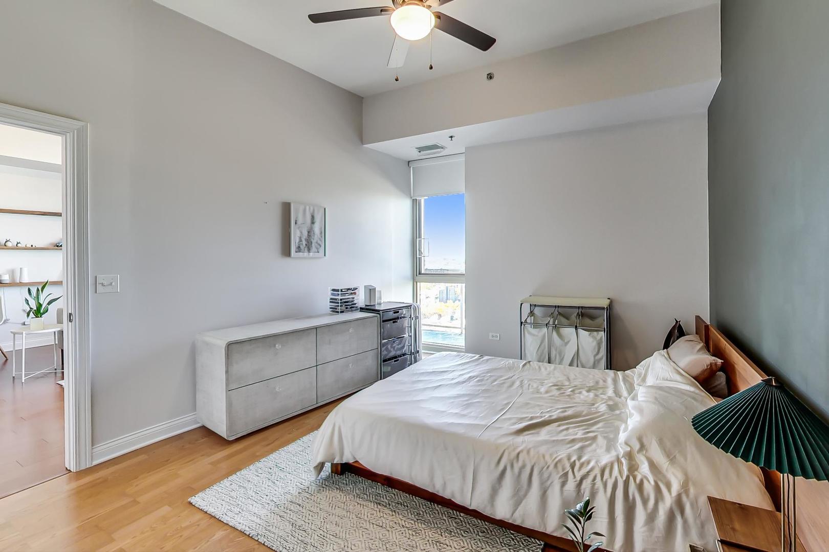 230 West Division Street, Unit 1307 Chicago, IL 60610 - Photo 15 of 33 a bedroom with a bed and a ceiling fan