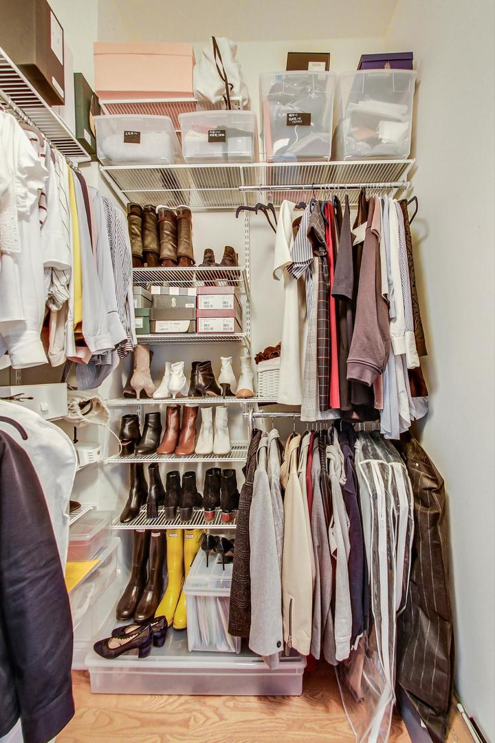 230 West Division Street, Unit 1307 Chicago, IL 60610 - Photo 19 of 33 a view of walk in closet with clothes and shoes
