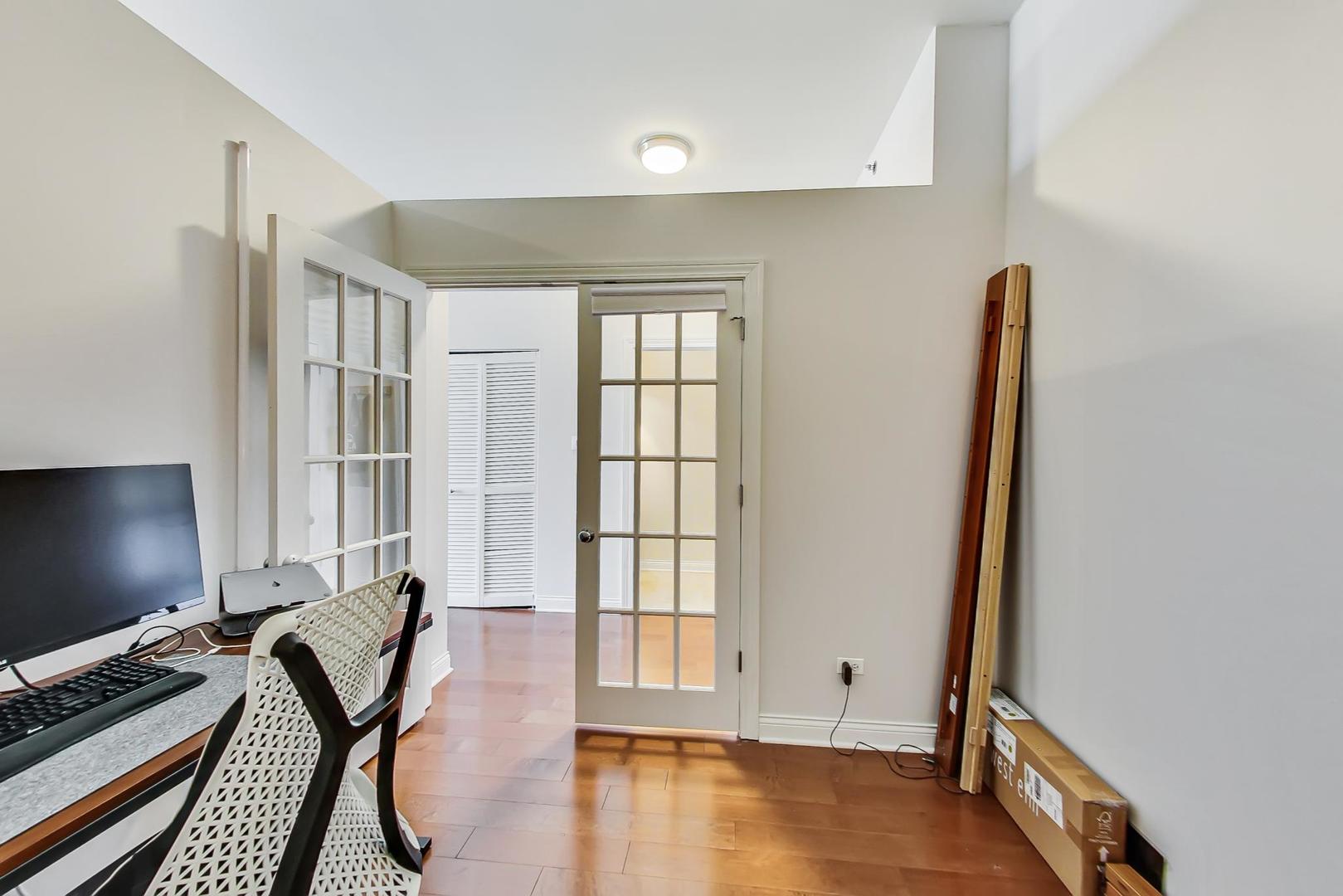 230 West Division Street, Unit 1307 Chicago, IL 60610 - Photo 21 of 33 a view of a workspace with furniture and a window