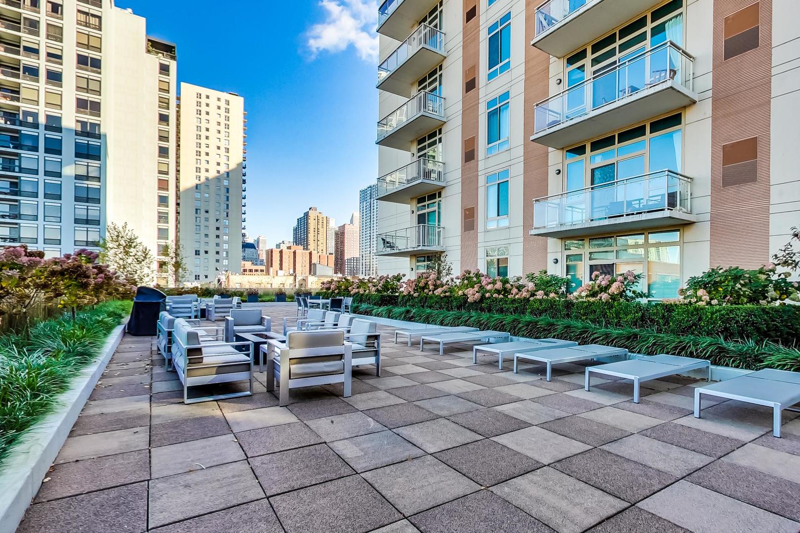 230 West Division Street, Unit 1307 Chicago, IL 60610 - Photo 27 of 33 a view of a patio with table and chairs and potted plants