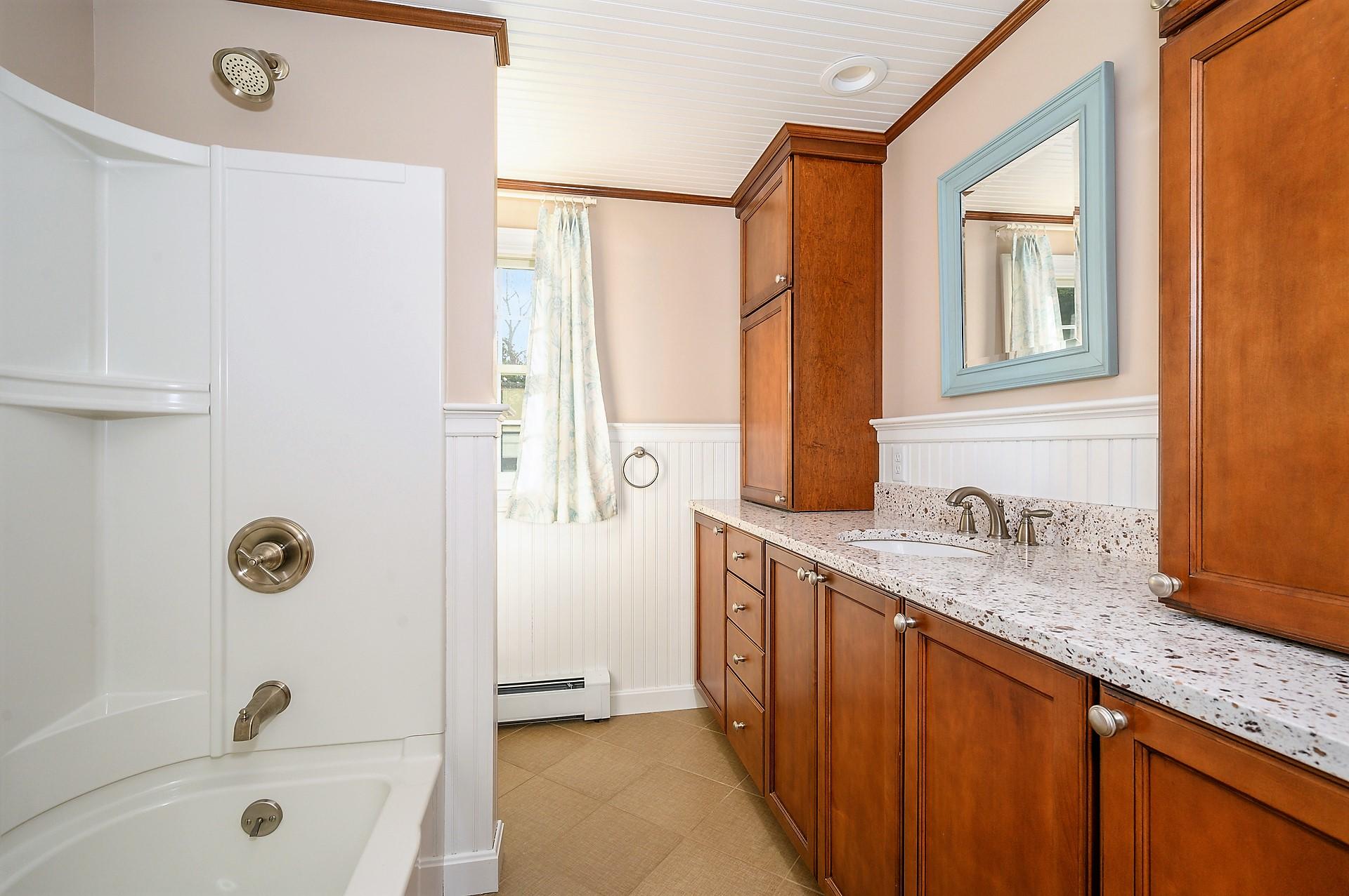 15 Captain Small Road South Yarmouth, MA 02664 - Photo 16 of 17 a bathroom with a granite countertop sink a mirror a shower and a bathtub