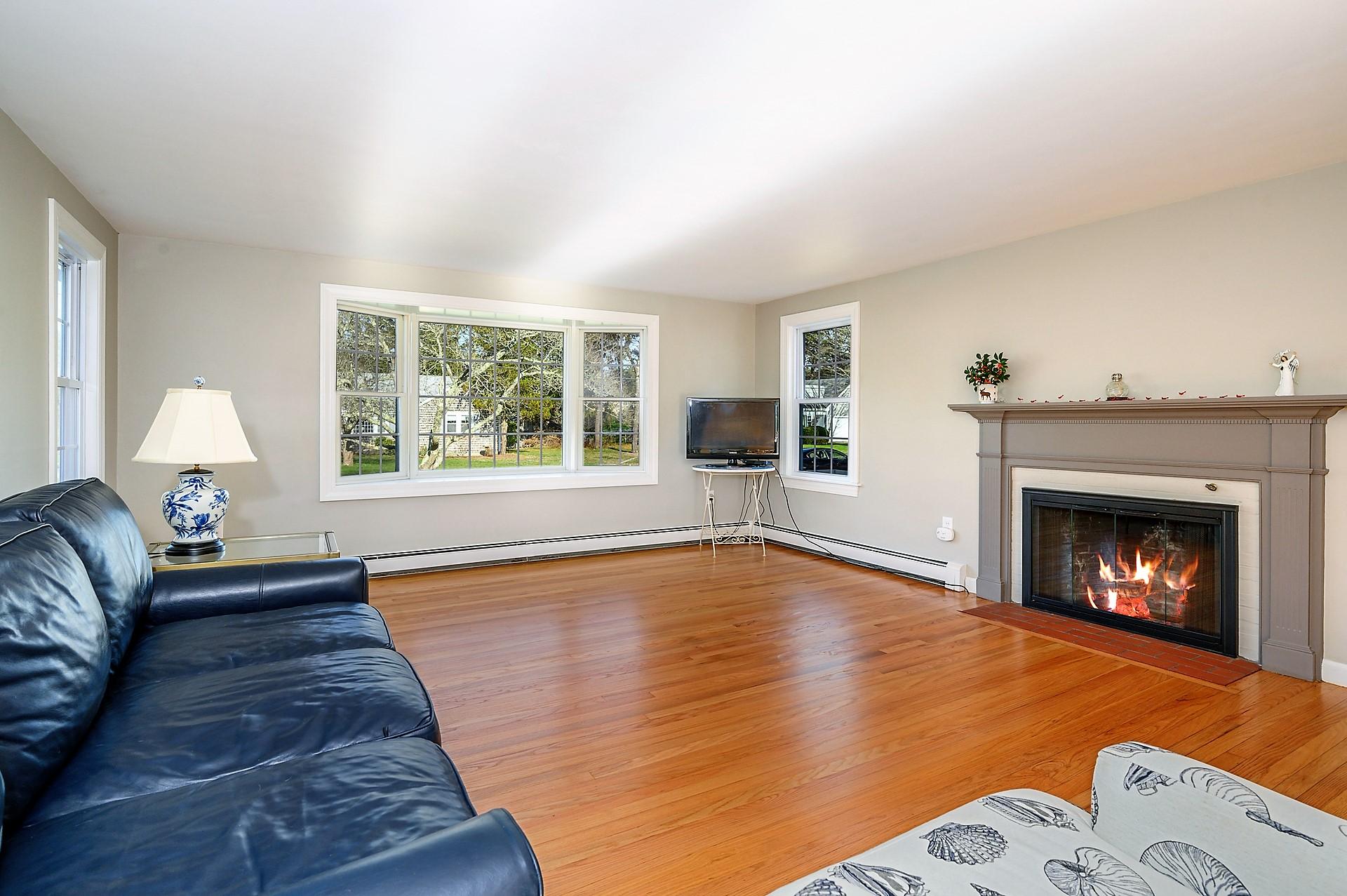 15 Captain Small Road South Yarmouth, MA 02664 - Photo 6 of 17 a living room with furniture and a fireplace