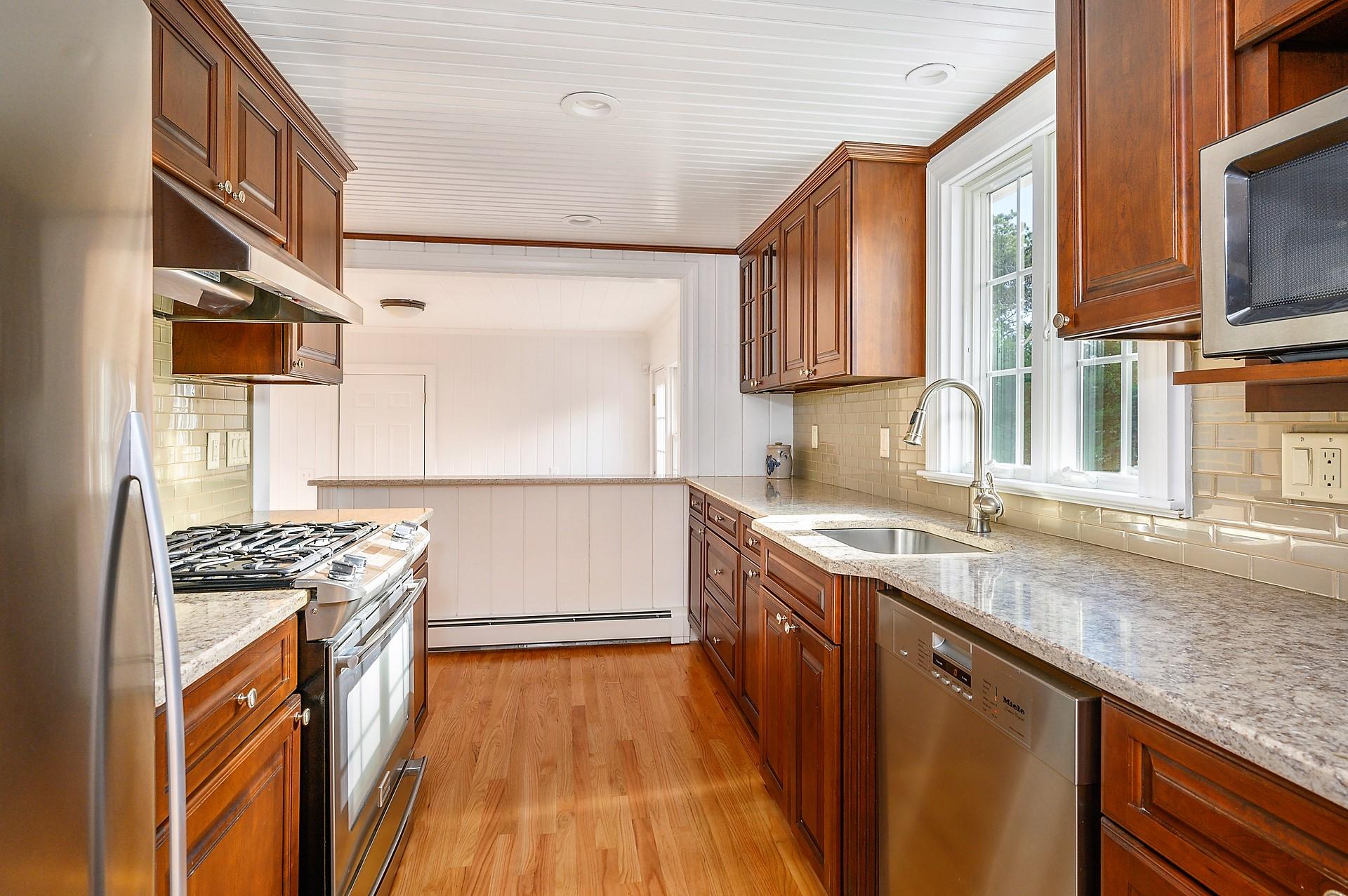 15 Captain Small Road South Yarmouth, MA 02664 - Photo 10 of 17 a kitchen with stainless steel appliances granite countertop a stove a sink and a microwave