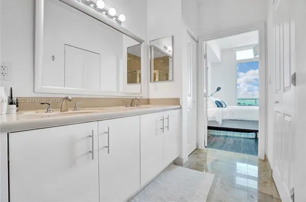 a spacious bathroom with a sink a mirror and a shower