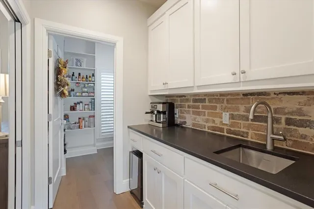 a kitchen with granite countertop a sink and a stove