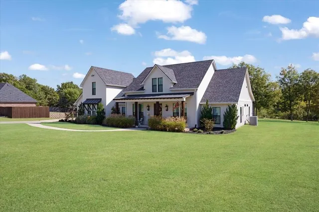 a front view of house with yard barbeque and outdoor seating
