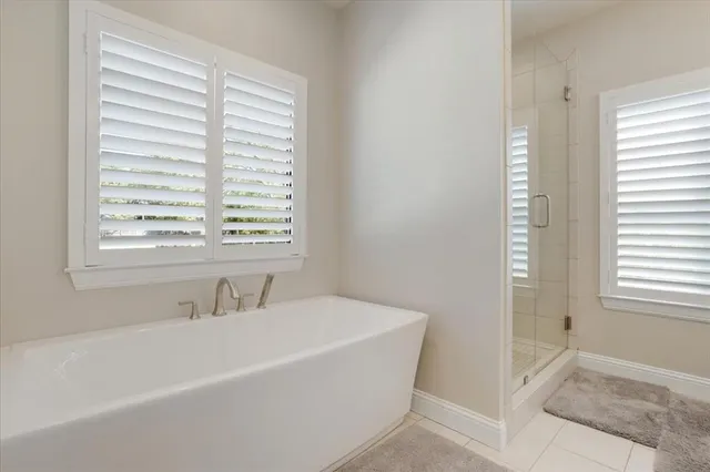 a white bath tub sitting next to a window