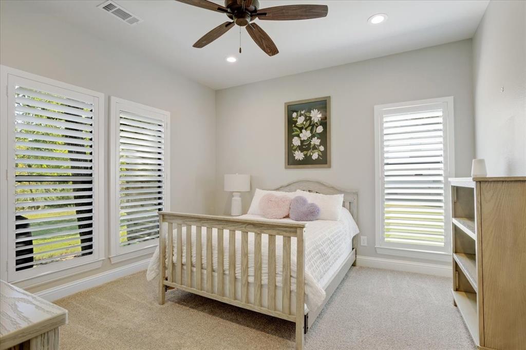 425 Ridgeview Road Sherman, TX 75092 - Photo 29 of 40 a bedroom with a bed and a chandelier