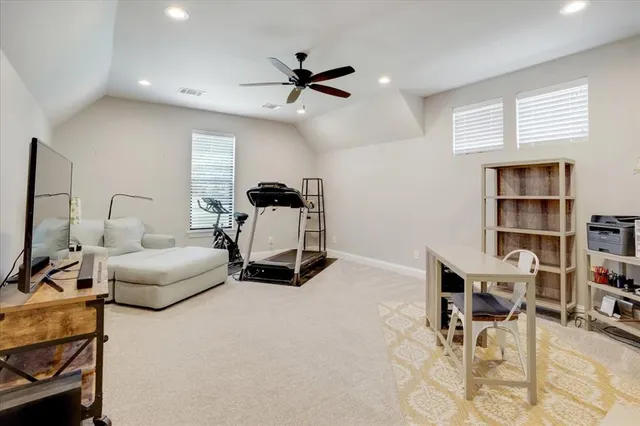 a living room with furniture and a book shelf