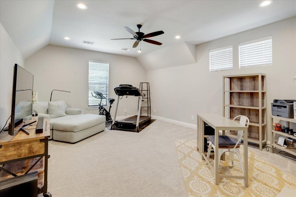 425 Ridgeview Road Sherman, TX 75092 - Photo 34 of 40 a living room with furniture and a book shelf