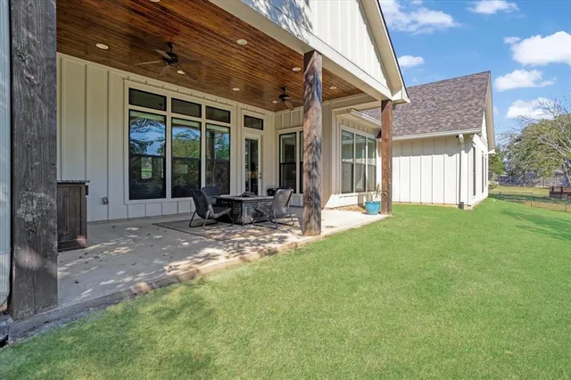 a view of a house with backyard porch and sitting area