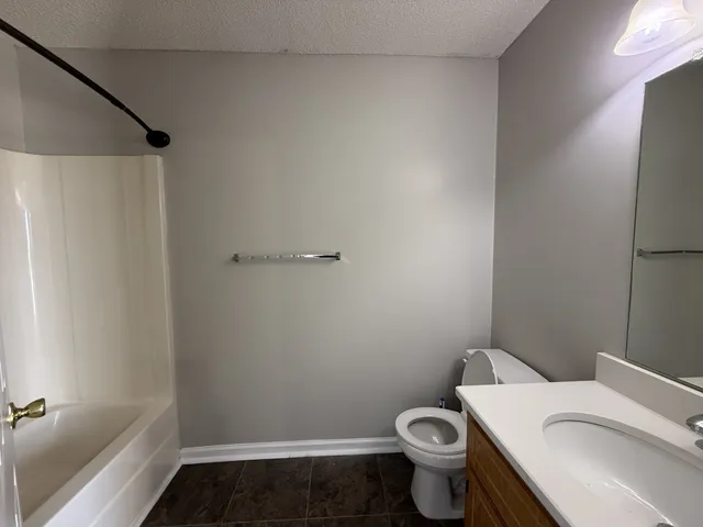 a white toilet sitting next to a bath tub