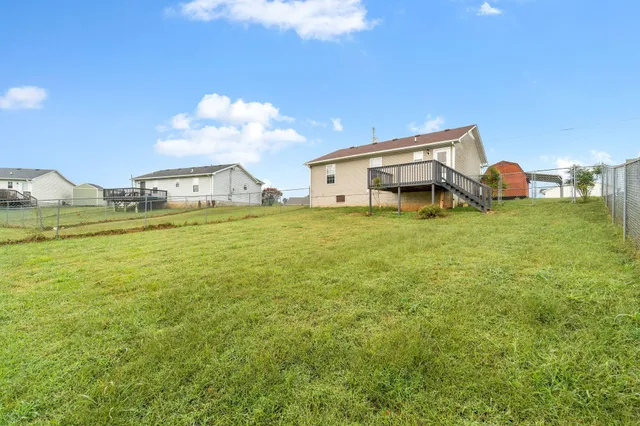 a backyard of a house with table and chairs
