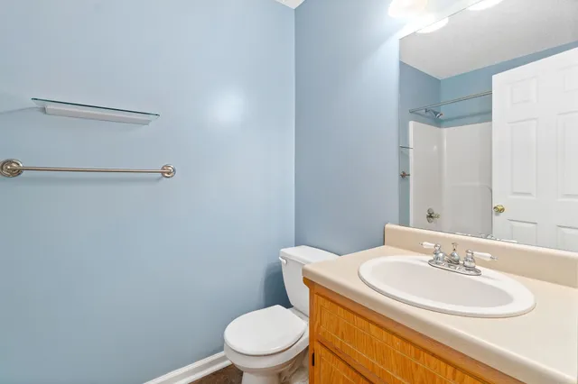 a bathroom with a sink a toilet and mirror