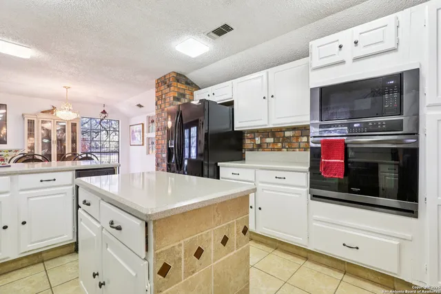 a kitchen with stainless steel appliances white cabinets and a stove