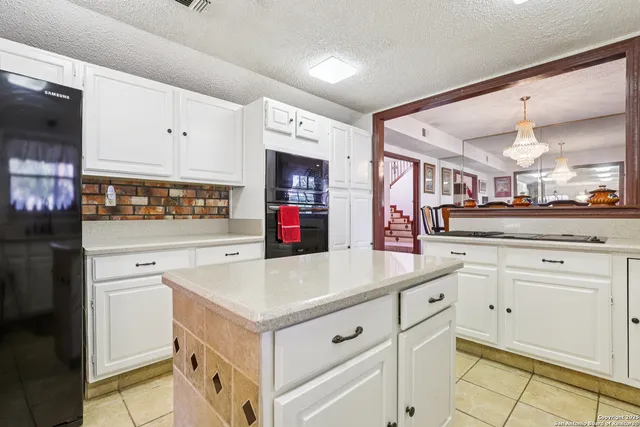 a kitchen with cabinets and window