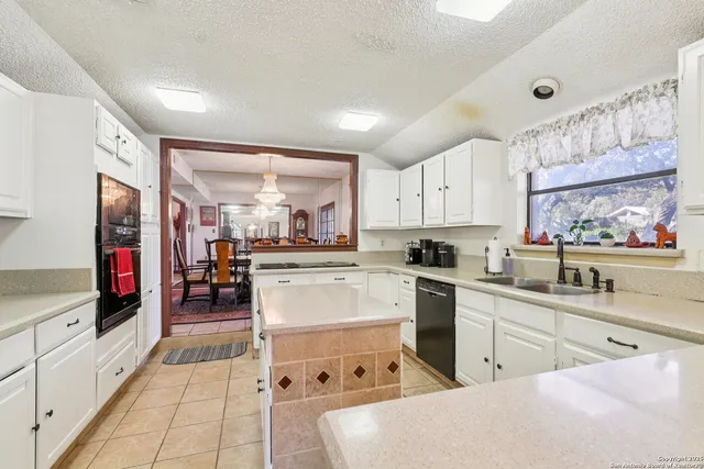 a kitchen with appliances cabinets and a sink