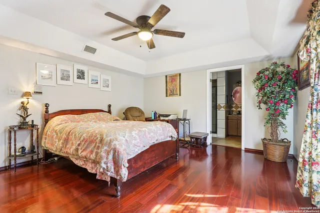 a spacious bedroom with a bed and a chandelier