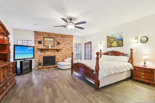 a spacious bedroom with a bed and a fireplace