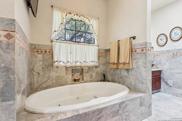a bathroom with a tub and a window