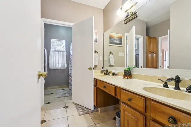 a spacious bathroom with a granite countertop sink mirror and a